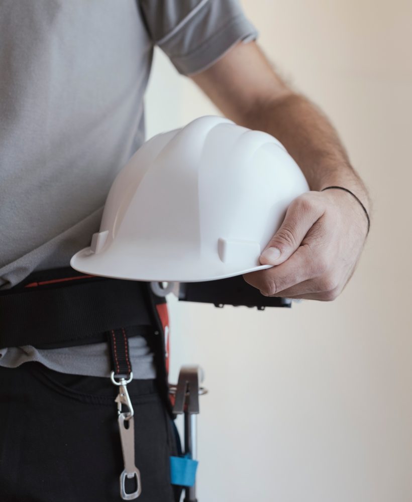 Construction worker holding a safety helmet